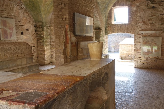 Ancient Ostia Antica Semi-Private Day Trip from Rome by Train with Guide - The amphitheater: Roman drama without the stadium hype