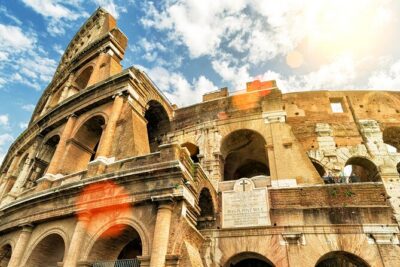 Colosseum, Roman Forum and Palatine Hill Skip Line Private Tour - Stepping onto the arena floor through the gladiator doors